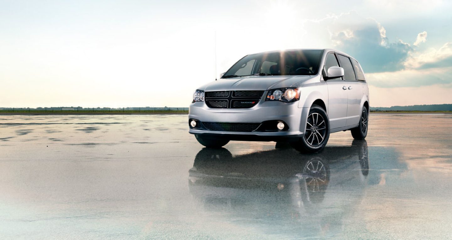 A 2019 Dodge Grand Caravan parked on a wet surface.