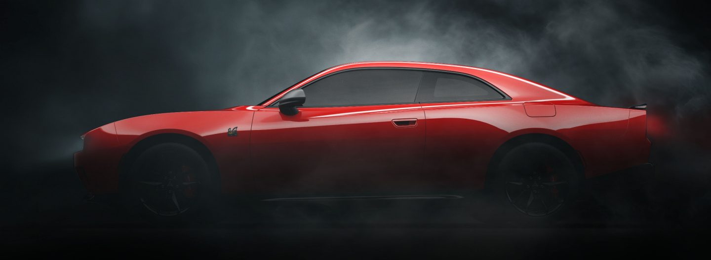 A driver-side profile of a red 2024 Dodge Charger Daytona Scat Pack Battery Electric Vehicle two-door in a darkened, smoke-filled studio.