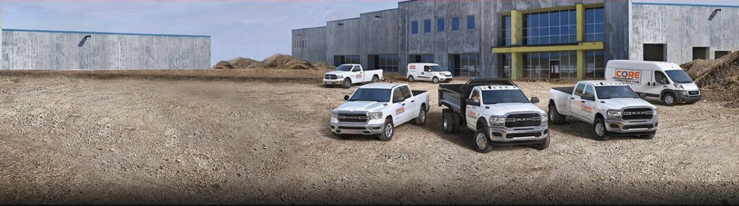Six Ram vehicles including the Ram ProMaster City, Ram 1500 Classic, Ram 1500, Ram Chassis Cab, Ram 3500, and Ram ProMaster parked side by side at a construction site.