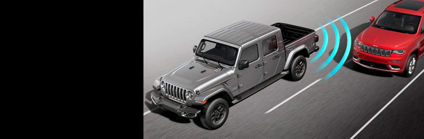 An illustration of the 2022 Jeep Gladiator Overland with sensor bars coming from its rear driver-side corner, detecting another vehicle in the next lane.