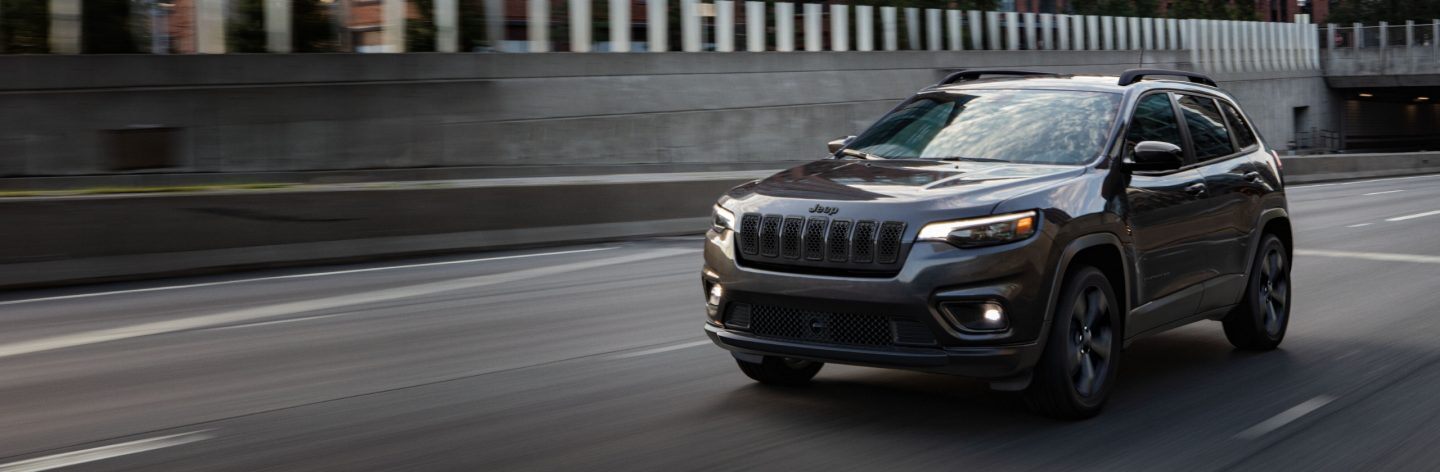 A 2023 Jeep Cherokee Altitude LUX being driven on a highway.