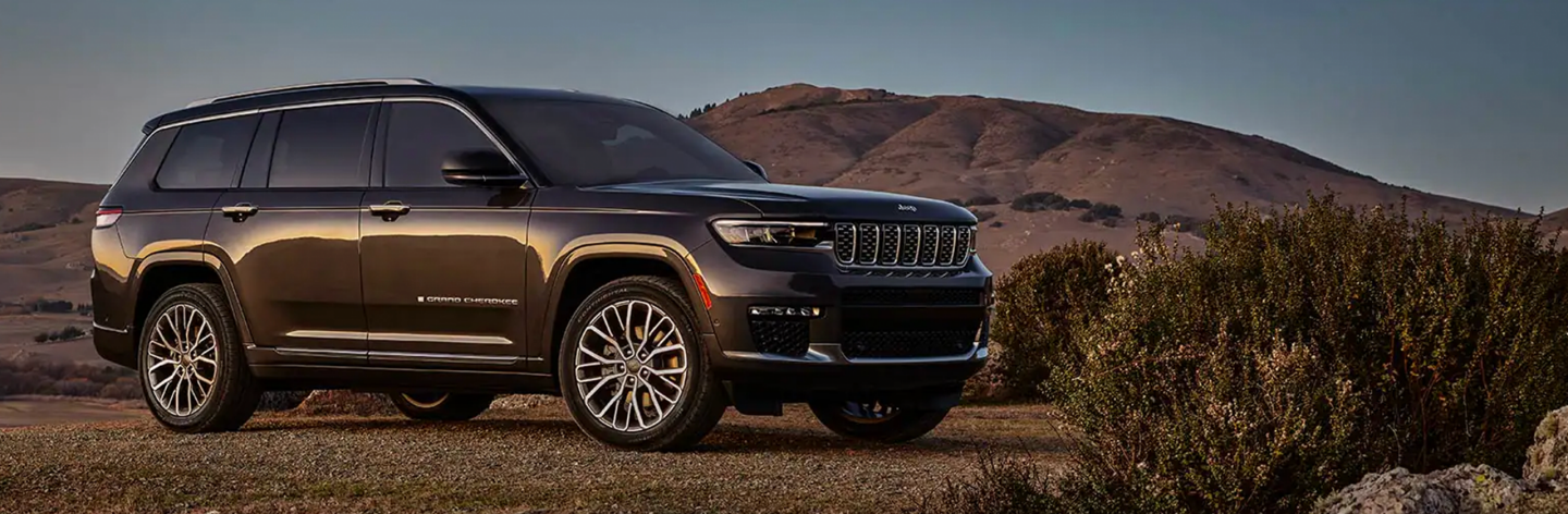 The 2023 Jeep Grand Cherokee Summit Reserve parked off-road in the desert.