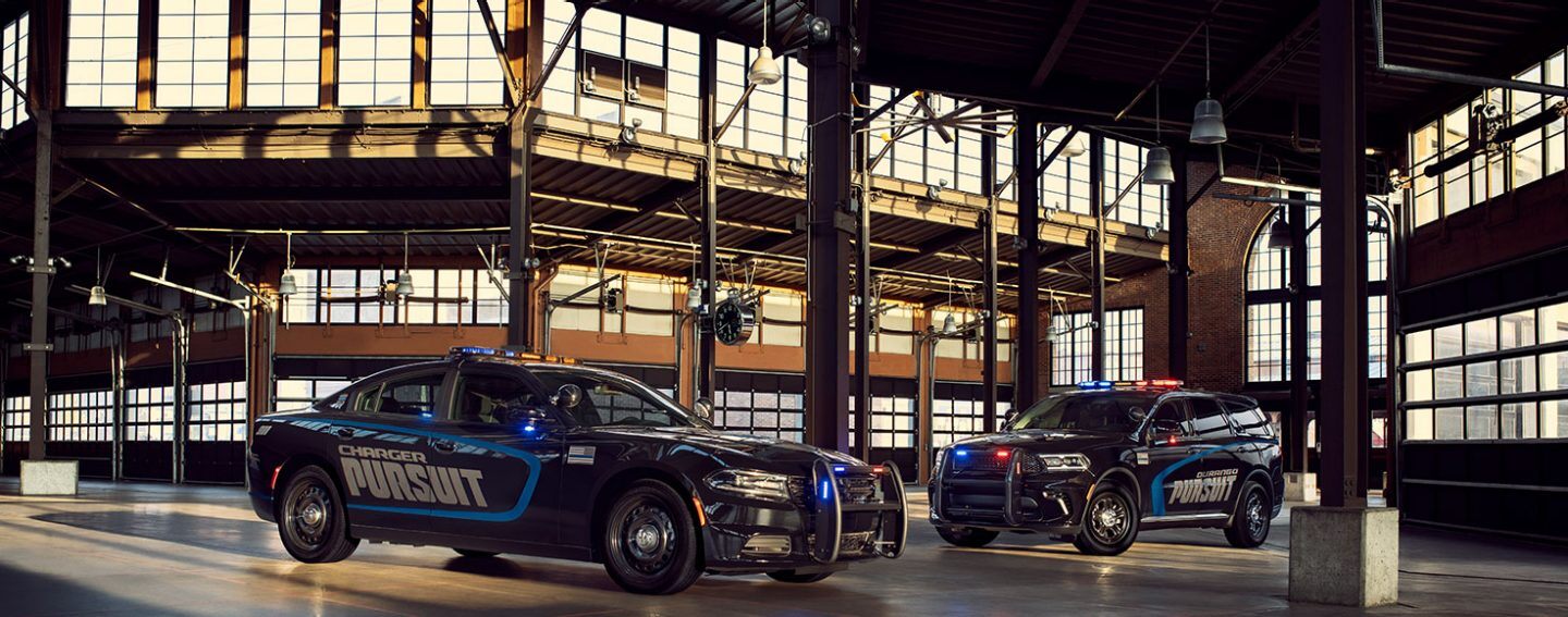 The 2022 Dodge Charger Pursuit and Dodge Durango Pursuit with rooftop and hood flashers illuminated.