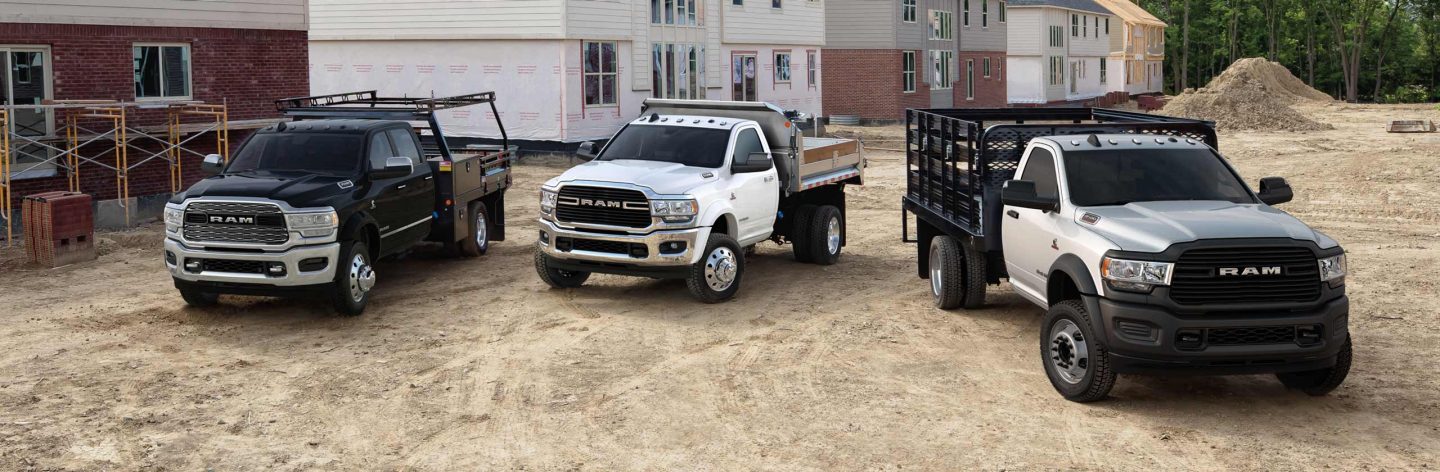 Three 2019 Ram Chassis Cab models on a construction site, all of them with construction upfits.