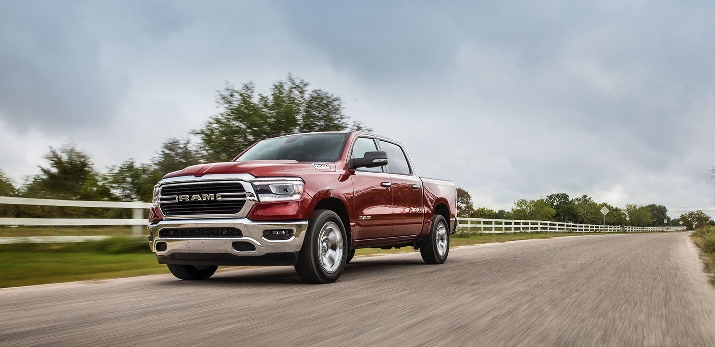 Display A 2020 Ram 1500 being driven on a country road.