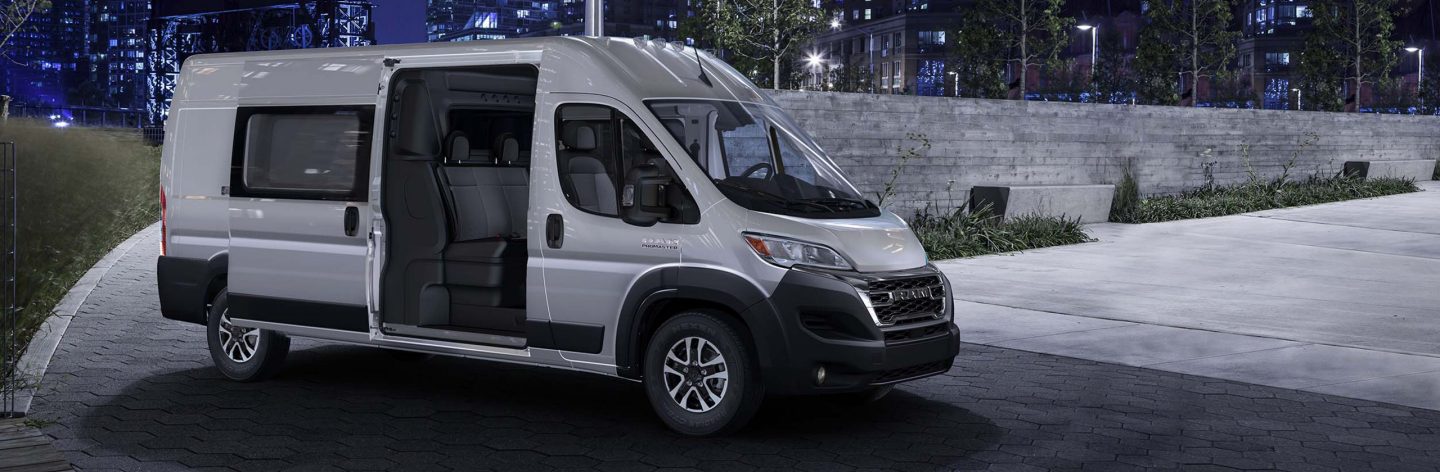 The 2023 Ram ProMaster Cargo Van High Roof with Crew Van Package—its sliding side door open to reveal the second row of seats.