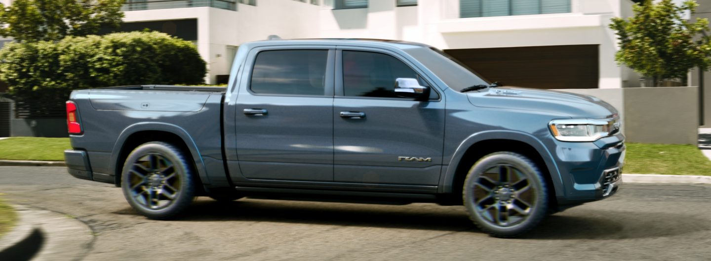 A passenger-side profile of an ice blue 2025 Ram 1500 Rev Tungsten Crew Cab.