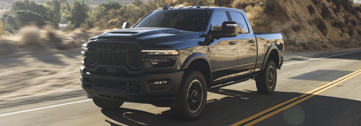 A gray 2026 Ram 2500 Rebel traveling down a highway.